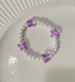Beaded pearl bracelet with purple butterflies 